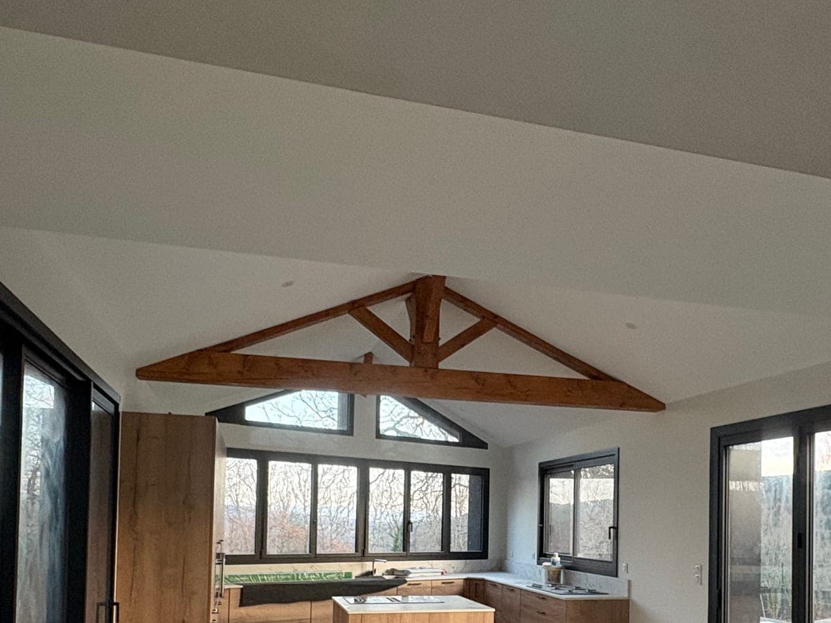 Charpente apparente en bois au-dessus d'une cuisine ouverte, rénovation à Saint-Priest-la-Prugne